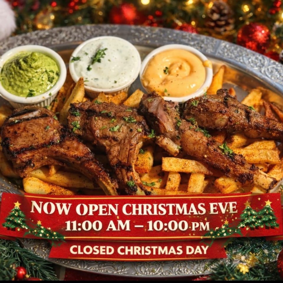 Grilled lamb chops with fries and three dipping sauces on a festive Christmas background.